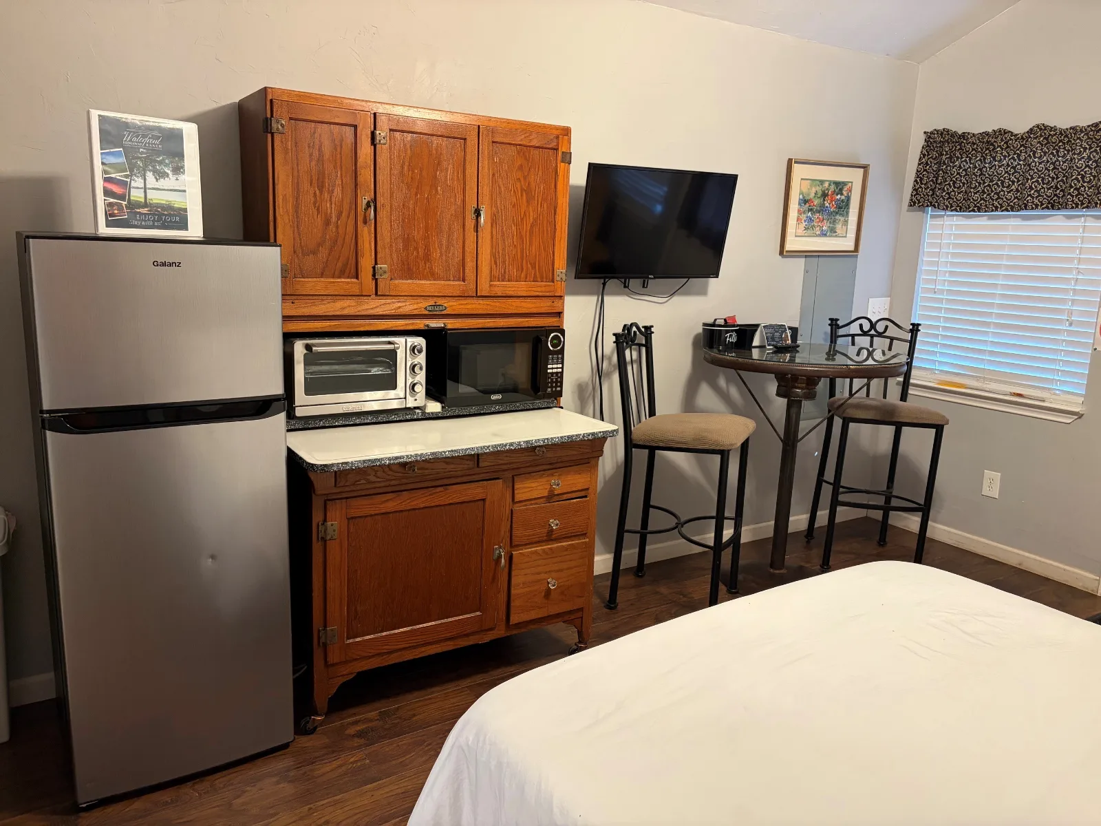 The kitchenette in Cabin 1, with a fridge, microwave and TV