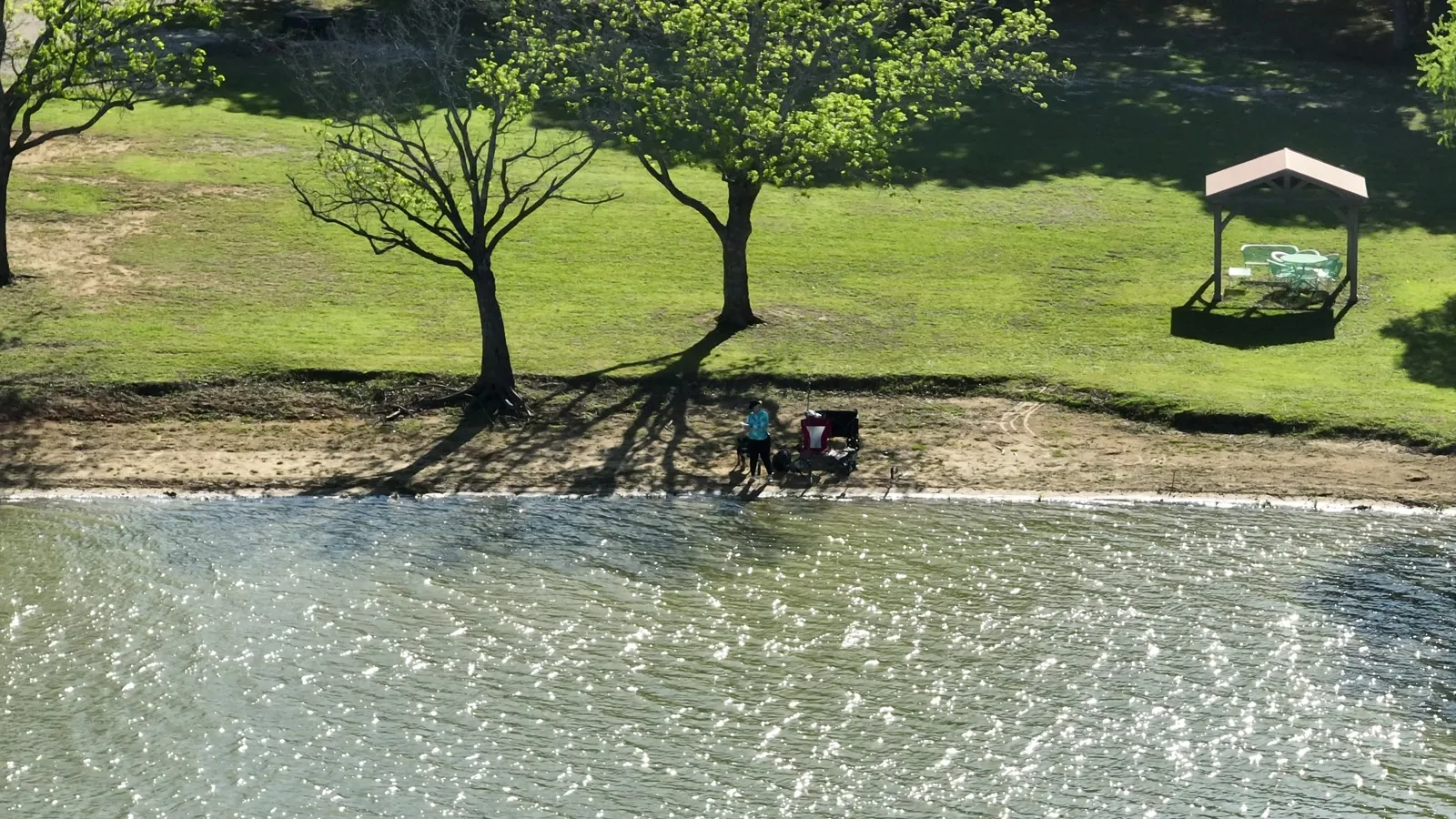 The gazebo and the grassy bank on the private Lake Lewisville shoreline at Waterfront Hideaway Ranch