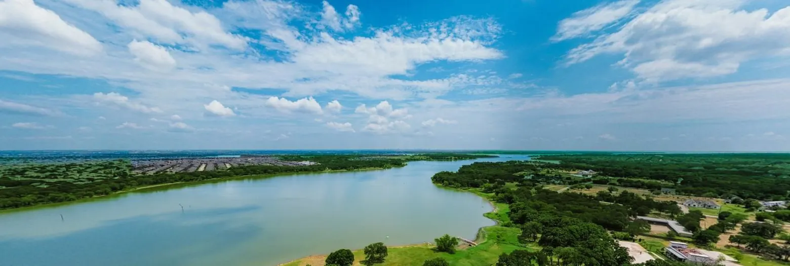 Aerial 360 view of Waterfront Hideaway Ranch on Lake Lewisville, showing the shoreline, oaks and RV rows